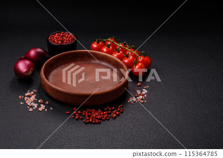 Empty ceramic round plate on dark textured concrete background Empty ceramic round plate on dark textured concrete background 115364785