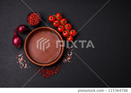 Empty ceramic round plate on dark textured concrete background Empty ceramic round plate on dark textured concrete background 115364786