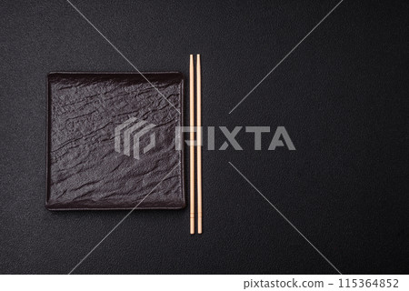 Empty ceramic round plate on dark textured concrete background 115364852