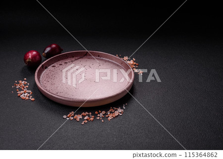 Empty ceramic round plate on dark textured concrete background 115364862