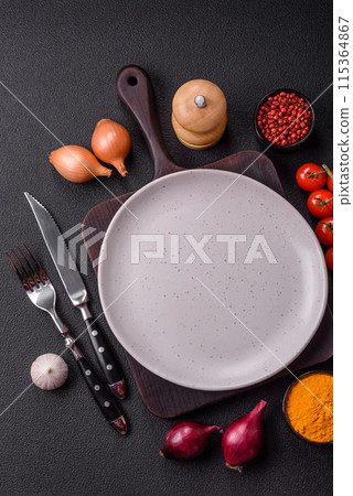 Empty ceramic round plate on dark textured concrete background Empty ceramic round plate on dark textured concrete background 115364867