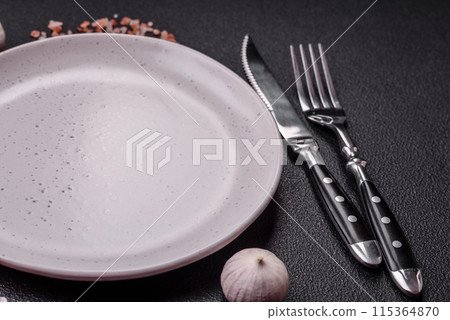 Empty ceramic round plate on dark textured concrete background 115364870