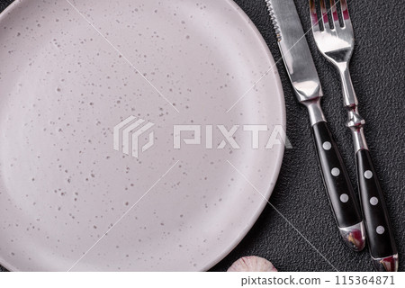 Empty ceramic round plate on dark textured concrete background 115364871