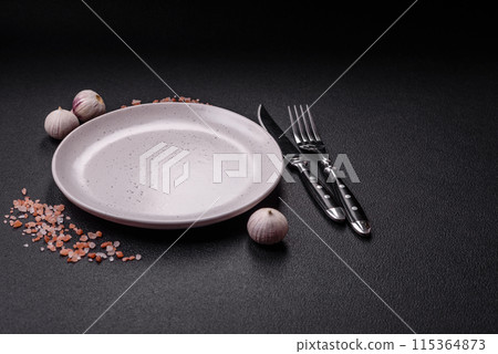 Empty ceramic round plate on dark textured concrete background 115364873