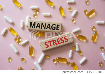 Manage stress symbol. Concept word Manage stress on wooden blocks. Beautiful pink background with pills. Medicine and Manage stress concept. Copy space Manage stress symbol. Concept word Manage stress on wooden blocks. Beautiful pink background with pills. Medicine and Manage stress concept. Copy space 115365100