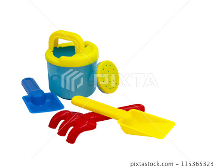 Children's toys for playing in the sand. Children's shovel, watering can and sandpit rake isolated without background. For text Children's toys for playing in the sand. Children's shovel, watering can and sandpit rake isolated without background. For text 115365323