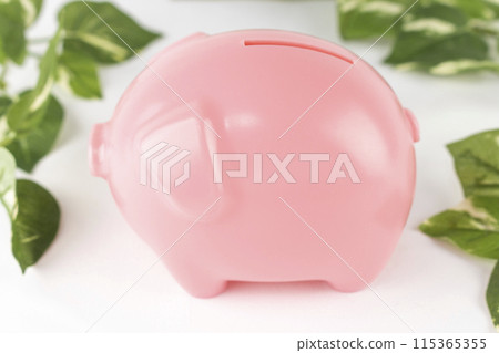 Pig money box and fake greenery. Savings image 115365355