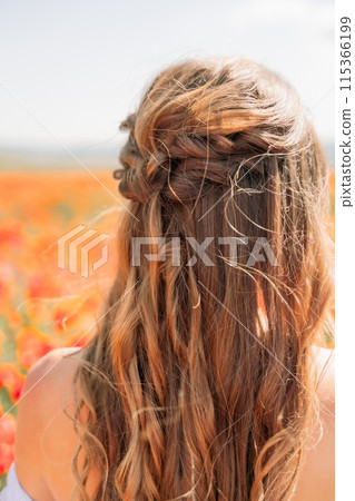 Woman poppies field. Side view of a happy woman with long hair in a poppy field and enjoying the beauty of nature in a warm summer day. Woman poppies field. Side view of a happy woman with long hair in a poppy field and enjoying the beauty of nature in a warm summer day. 115366199