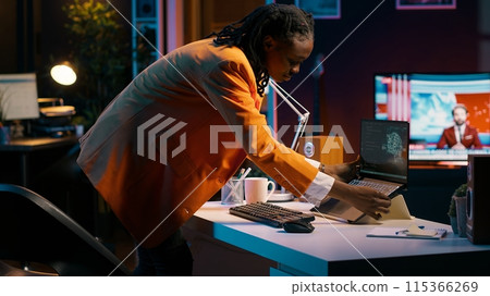 African american girl studying servers providing AI computing resources, learning to program html scripts on artificial intelligence neural network system. Woman uses coding language. Camera A. African american girl studying servers providing AI computing resources, learning to program html scripts on artificial intelligence neural network system. Woman uses coding language. Camera A. 115366269
