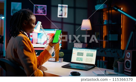 Student uses greenscreen on phone layout while she examines cash plan software for economy course research. Girl learning about expenses and earnings, looks at blank copyspace. Camera B. 115366370
