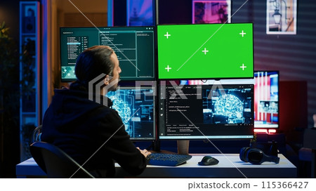 Hacker using green screen monitor and artificial intelligence to write spyware software gathering data from users. Scammer in apartment using AI and mockup PC display to do fraud using AI, camera A Hacker using green screen monitor and artificial intelligence to write spyware software gathering data from users. Scammer in apartment using AI and mockup PC display to do fraud using AI, camera A 115366427