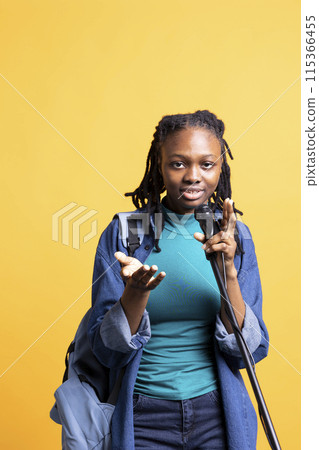 African american woman holding microphone, performing songs in concert, isolated over studio background. Energetic BIPOC musician singing to spectators, doing karaoke, having fun African american woman holding microphone, performing songs in concert, isolated over studio background. Energetic BIPOC musician singing to spectators, doing karaoke, having fun 115366455