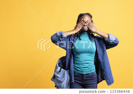 Tired BIPOC woman covering face with palms, exhausted after long day at work. African american person in need of break from job, obstructing eyes with hand, isolated over studio background Tired BIPOC woman covering face with palms, exhausted after long day at work. African american person in need of break from job, obstructing eyes with hand, isolated over studio background 115366456