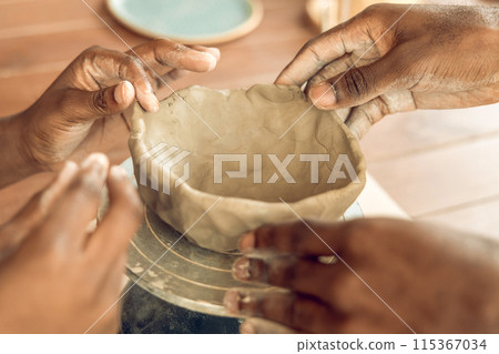 Close up of human hands molding clay and shaping it 115367034