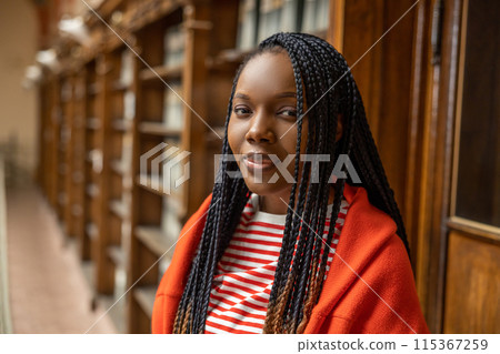 Portrait of a long-haired african american young woman in the library Portrait of a long-haired african american young woman in the library 115367259