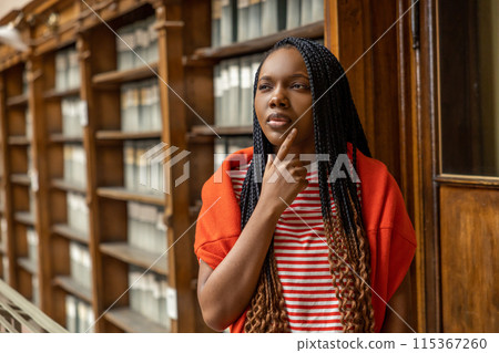 Portrait of a long-haired african american young woman in the library Portrait of a long-haired african american young woman in the library 115367260