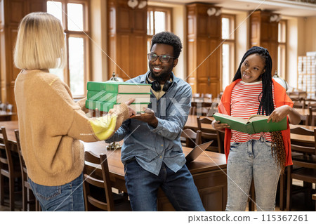 Group of young people in the library looking busy and involved 115367261