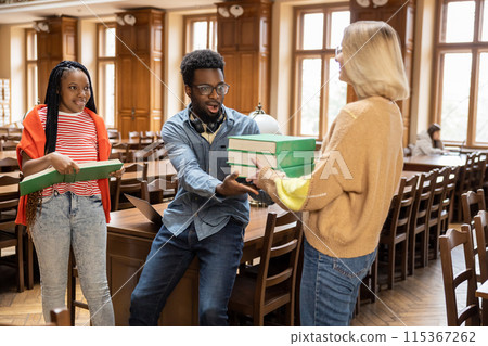 Group of young people in the library looking busy and involved 115367262