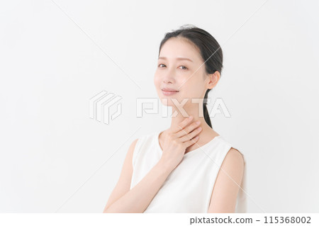 Portrait of a woman touching her neck Portrait of a woman touching her neck 115368002