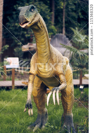 A predatory dinosaur with hypertrophied claws is a Therizinosaurus. The strangest of the dinosaurs that lived at the very end of the Cretaceous period. With space to copy. High quality photo A predatory dinosaur with hypertrophied claws is a Therizinosaurus. The strangest of the dinosaurs that lived at the very end of the Cretaceous period. With space to copy. High quality photo 115368320