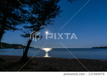 Serene moonset reflecting in the sea at the beach. Iriomote island, Okinawa. Serene moonset reflecting in the sea at the beach. Iriomote island, Okinawa. 115368478