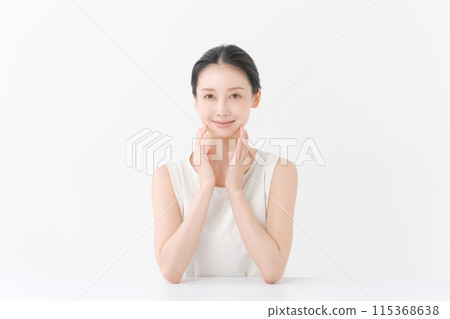 woman smiling with hand on cheek 115368638