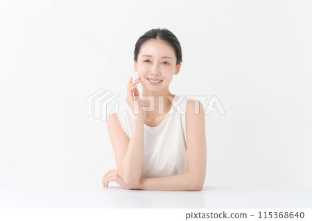 woman smiling with hand on cheek 115368640