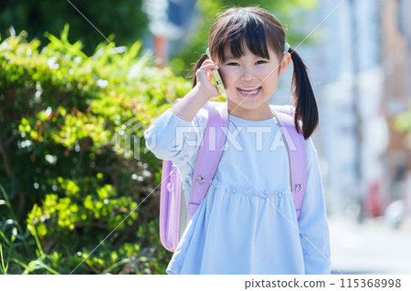 Elementary school students using kids' cell phones 115368998