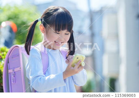 Elementary school students using kids' cell phones 115369003