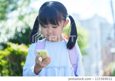 Elementary school students using kids' cell phones 115369012