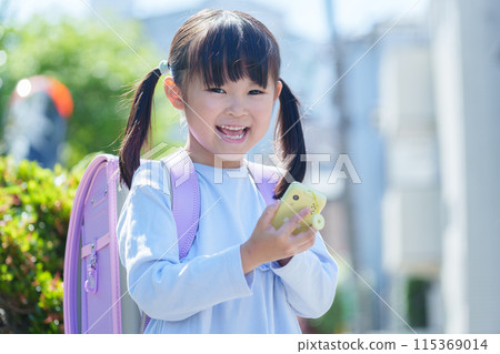Elementary school students using kids' cell phones 115369014