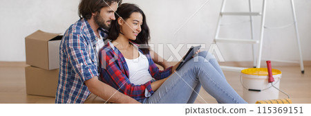 Focused Couple with Tablet Sitting on Floor for DIY Home Makeover Banner Focused Couple with Tablet Sitting on Floor for DIY Home Makeover Banner 115369151