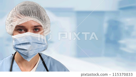 Portrait of female surgeon wearing face mask against hospital in background 115370833