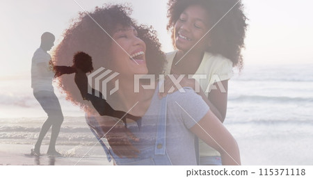 Composite of happy african american mother and daughter, and father and daughter playing on beach 115371118