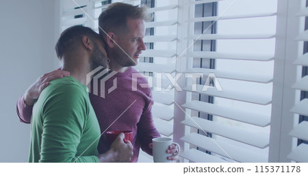 Diverse gay couple enjoys a quiet moment at home, with copy space Diverse gay couple enjoys a quiet moment at home, with copy space 115371178