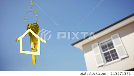 Image of golden house keys and house shaped key fob hanging over a house and blue sky 4k Image of golden house keys and house shaped key fob hanging over a house and blue sky 4k 115371571