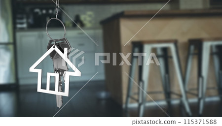 Image of silver house keys and house shaped key fob hanging over an out of focus open plan kitchen 4 115371588