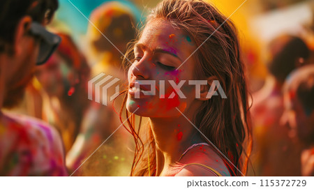 Happy young woman having fun in crowd at Holi festival of colors, summer party or music festival 115372729