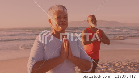 African american senior couple practicing yoga together at the beach 115373418