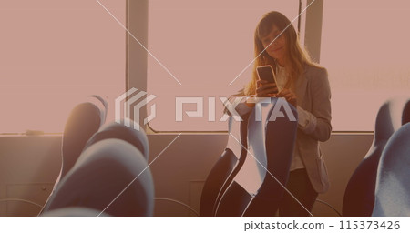 Caucasian businesswoman smiling while using smartphone standing in the bus Caucasian businesswoman smiling while using smartphone standing in the bus 115373426
