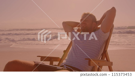 Caucasian man sitting on the chair and relaxing at the beach 115373453