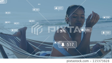 Image of social media reactions over happy african american woman in hammock on beach Image of social media reactions over happy african american woman in hammock on beach 115373828