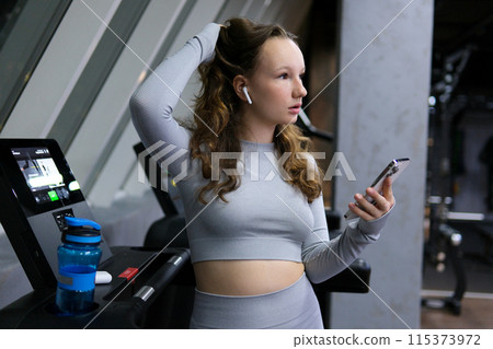 Girl running track Back view of female legs walking and running on treadmill in gym, woman training Girl running track Back view of female legs walking and running on treadmill in gym, woman training 115373972