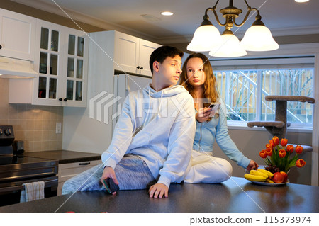 Romantic smiling couple young guy and girl sit on warm kitchen floor talking holding glasses having fun together, happy friendly husband and wife laughing enjoying drinking red wine at modern home Romantic smiling couple young guy and girl sit on warm kitchen floor talking holding glasses having fun together, happy friendly husband and wife laughing enjoying drinking red wine at modern home 115373974