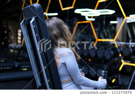 Concentrated cute little girl doing sport exercises with dumbbells in gym, slow motion. Physical sport activities for children Concentrated cute little girl doing sport exercises with dumbbells in gym, slow motion. Physical sport activities for children 115373976