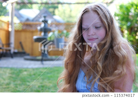 Charming smiling confident young caucasian woman with beautiful face looking at camera, posing alone in nature in field. Happy millennial caucasian woman model professional close-up front portrait. 115374017