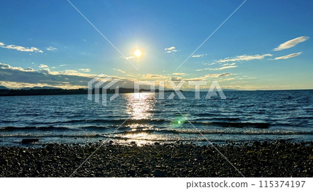 the sun is setting over the stone beach the reflections Pacific Ocean is very quiet and calm there are no waves relaxing music background for titles and advertising Parksville beach Surfside RV resort 115374197
