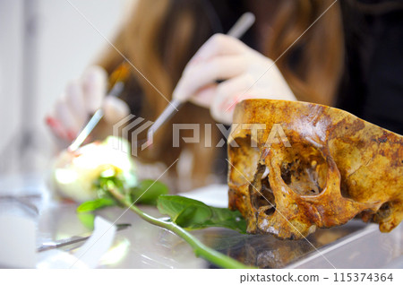 close-up of human skull hands surgeon doctor in special gloves and tools for operation concept of treatment surgical intervention operation is performed on white rose to demonstrate process of surgery close-up of human skull hands surgeon doctor in special gloves and tools for operation concept of treatment surgical intervention operation is performed on white rose to demonstrate process of surgery 115374364