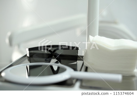 white mirror and black glasses napkins dentistry hospital research close-up space for text laboratory beauty items Beauty Salon rest dental office background white furniture to examine patients teeth 115374604