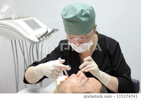 dentistry office tools woman doctor injects anesthesia with carpool syringe to patient dental operation dentistry office tools woman doctor injects anesthesia with carpool syringe to patient dental operation 115374741